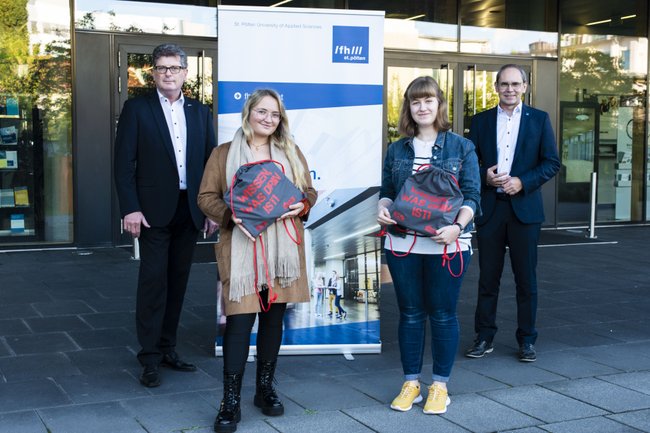 AK-Vizepräsident Michael Fiala (links) und FH St. Pölten Geschäftsführer Gernot Kohl (rechts) mit Studierenden