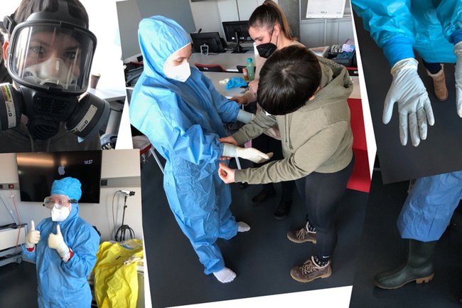 Studierende im Freifach Barrier Nursing beim Anlegen der Schutzausrüstung